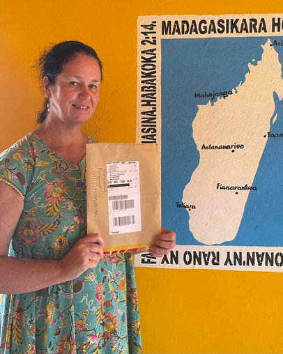 Rachel Jane Wallace in front of a painted map of Madagascar